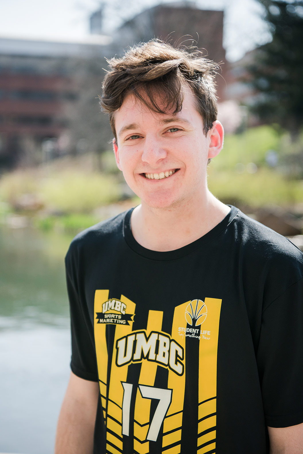 Jake, a smiling student in UMBC shirt.